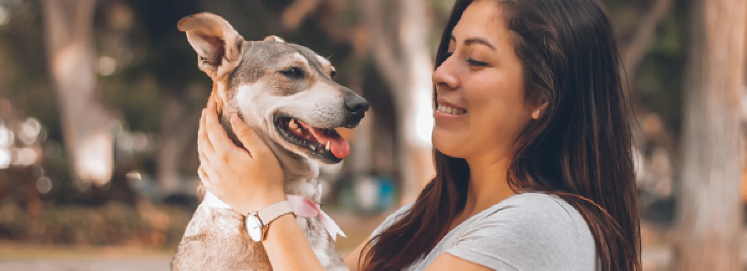 Dog with woman owner face to face smiling at each other